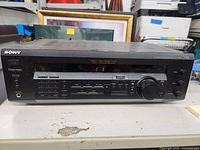 Front view of Sony audio/video control center showing control buttons and large volume knob