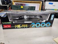 Front and side view of the diecast 2000 Lincoln limousine inside its original Sun Star box