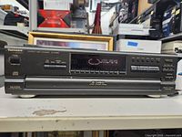 Front view of the Technics SL-PJ30A CD changer front panel showing disc slot, buttons, and display.