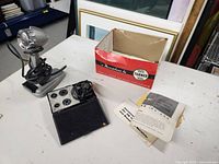 Full lot overview showing microphone on stand, original box, black accessory case, and instruction manuals