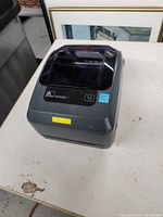 Zebra GX420t label printer closed, showing model and brand on top.
