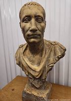 Front view of the bust showing Julius Caesar's detailed face and draped Roman attire.
