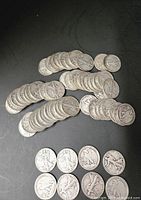 Stacks and loose half dollars on black background, obverse and reverse visible