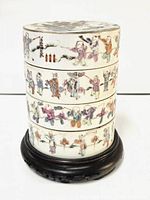 Assembled four-tier box with lid on wooden stand