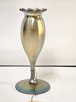 Front view of iridescent aurene footed floriform vase