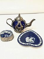 Photo showing the full set of three collectible cobalt blue items: teapot, jasperware trinket holder, and porcelain jewelry box.