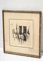 Framed etching depicting mounted soldiers in uniform near a building with open shutters.