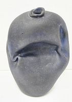 Front view showing the vase's irregular, organic shape and matte stone-like texture in cobalt blue.