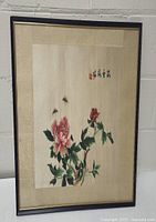 Framed vintage Japanese silk floral artwork showing hand embroidery of flowers and bees with Japanese calligraphy.