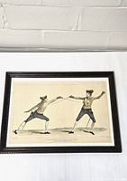 Framed hand-colored lithograph showing two men fencing, mounted in a dark wood frame.