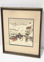 Framed watercolor artwork of horse race in snowy village showing multiple horse sleighs and village buildings under snow.