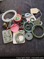 Top-down view of all jade pieces displayed on dark fabric