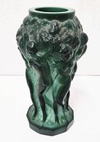 Full side view of malachite green glass vase showing embossed female nudes and grapes in satin finish.
