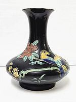 Front view of black cloisonne vase with floral and bird decorations showing the flared mouth and round body.
