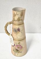 Photo showing the front side of the Royal Worcester jug with visible floral detail and bamboo textured handle.