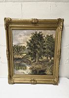Full front view of the framed landscape painting showing the scene and ornate gold frame.