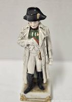 Front view of the hand painted porcelain figurine of Napoleon Bonaparte showing detailed clothing, hat, and base.