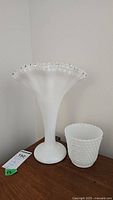 Photo showing the full shape and size comparison of the Fenton Silvercrest Petticoat Fan vase (13 inches) and the smaller milkglass hobnail pot (5 inches).
