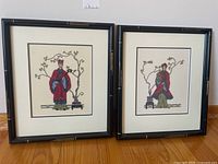 Two framed petit point needlepoint artworks showing Eastern figures in traditional robes with bonsai tree backgrounds, with black bamboo-style frames.