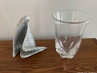 Photo showing Rosenthal Studio Line abstract Madonna figurine with crackle glaze pattern next to Orrefors clear glass vase with flared rim and sculptural base on wood surface.