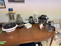 Wide view of entire lot showing all appliances and accessories on a wooden table