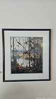 Framed print of Northern River by Tom Thomson showing the full artwork within black frame and white matting.