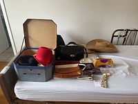 Overview shot showing hats, handbags, and some accessories on bed