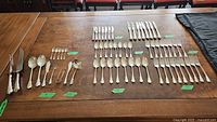 Overview of laid-out flatware pieces showing all 62 components