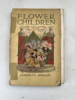 Front cover of antique children's book 'Flower Children' by Elizabeth Gordon showing colorful illustration of children dressed as flowers at garden entrance, with visible wear and tape repair.