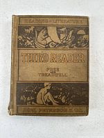 Front cover of 1912 Third Reader textbook showing detailed illustrated cloth binding with title and author names.