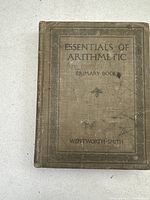 Front cover of the Essentials of Arithmetic textbook with title and author: Wentworth-Smith.