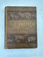 Front cover of the book showing title and illustrations of animals, with wear and age marks visible.