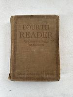 Front cover of the book showing title 'Fourth Reader Progressive Road to Reading' and 'California State Series'. Worn brown cloth cover.