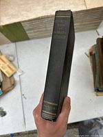 Spine of the book showing title 'REFERENCE BOOK OF INORGANIC CHEMISTRY' and publisher 'McMILLAN' at the bottom.
