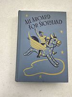 Front cover of the 1941 All Aboard for Storyland textbook featuring an illustration of a boy on a winged horse.