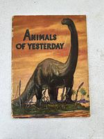 Front cover of the 1941 Animals of Yesterday textbook showing dinosaur illustration and title