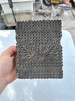 Front side of the antique wooden printing block showing intricate floral carving.