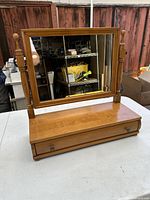 Front full view of antique wooden mini cabinet with mirror on a white surface.
