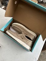 Pair of light beige slip-on Reef casual shoes in original box, size 11.5