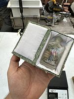 Snuff bottle displayed in box showing the packaging and size relative to hand