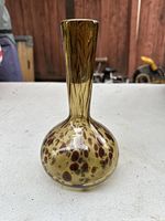 Full view of the vase showing the tortoise shell pattern, bulbous base, and narrow neck.