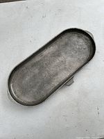 Top view of large cast aluminum griddle showing cooking surface with signs of use.