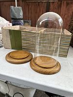 Glass display dome on one wooden base, another wooden base beside