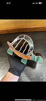 Handmade turtle piggy bank showing the top and body with stained glass shell and redwood body.