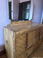 Side angle showing the table surface, side panel wood cracks, and drawer handles.