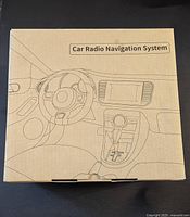 Box of the Car Radio Navigation System with line drawing of car dashboard and steering wheel, showing front view of the integrated navigation system.