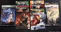 Image showing front covers of multiple ImagineFX magazines with fantasy and sci-fi themed artwork including Iron Man and various characters with weaponry and futuristic elements.
