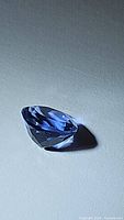 Photo of pear-shaped cornflower blue fluorite gemstone showing the facets and clarity.
