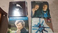 Top view of assorted country and folk LP albums stacked, featuring Gordon Lightfoot and Cashman & West.