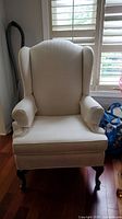 Front view of chair showing full seat, back, armrest, and cushion condition with visible stains.